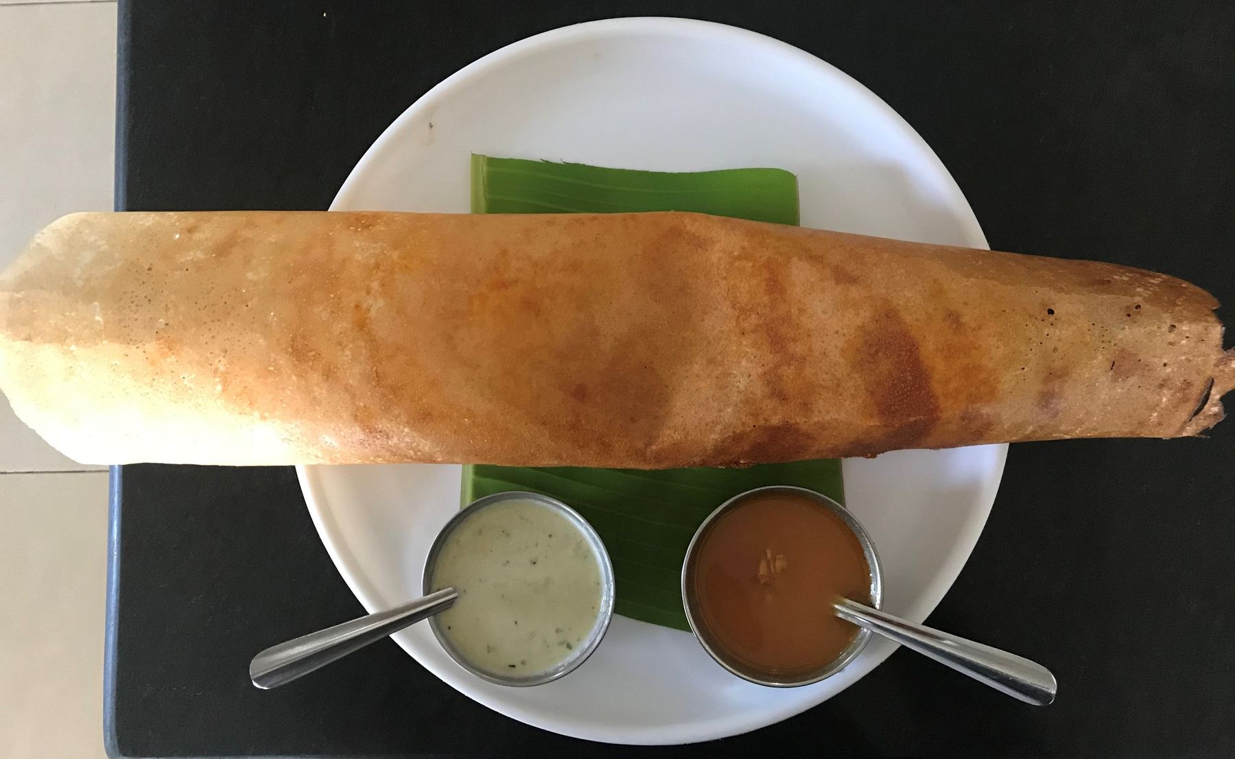 Placeholder photo: a giant golden dosa served on a large tray, representing Garuda's signature 4-foot Family Dosa — to be replaced with the restaurant's own photo