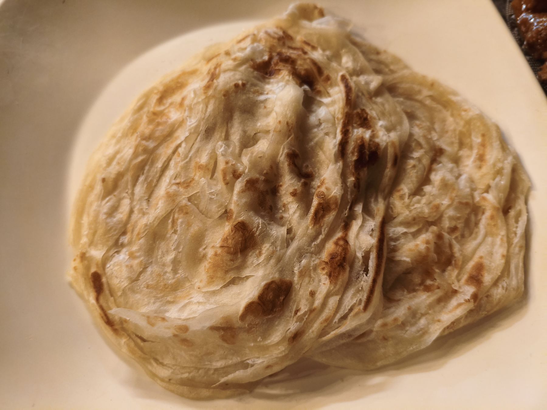 Placeholder: flaky layered Kerala porotta bread